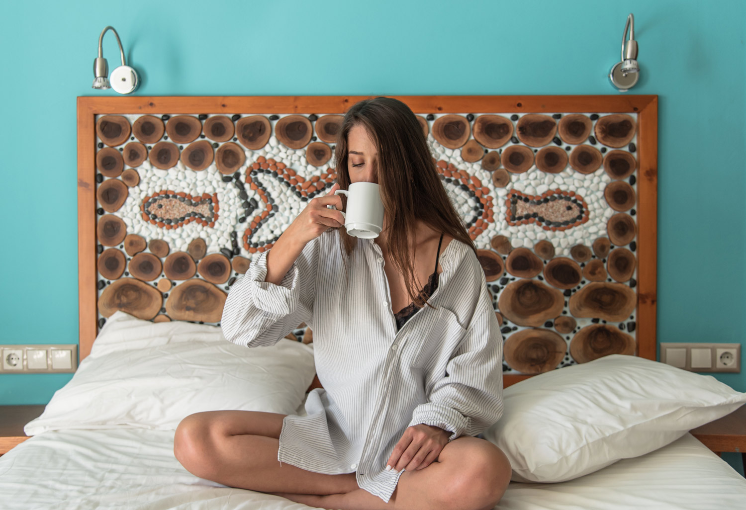 Woman drink coffee at the bed 