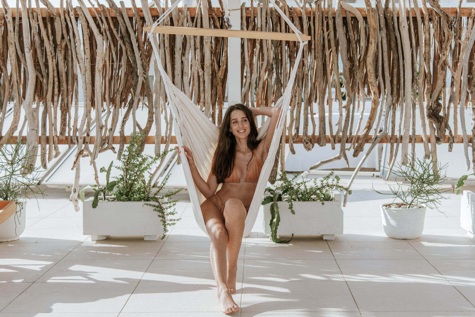 Woman relaxing on a hammock at hotel