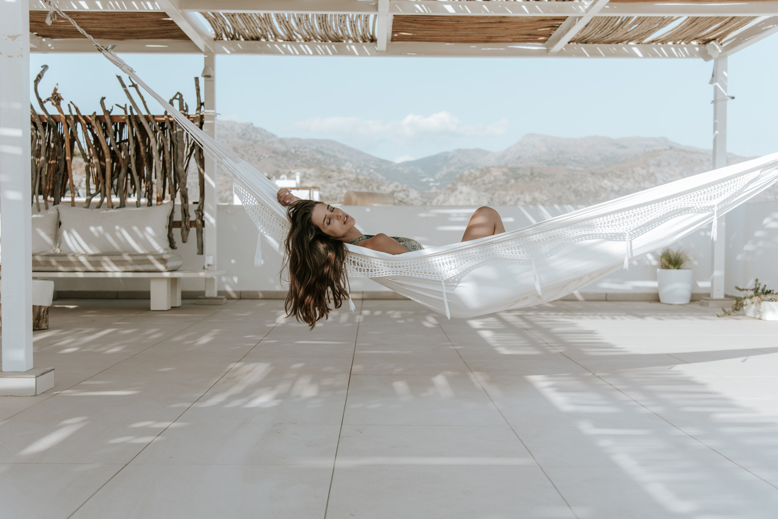 Woman relaxing on a hammock at hotel