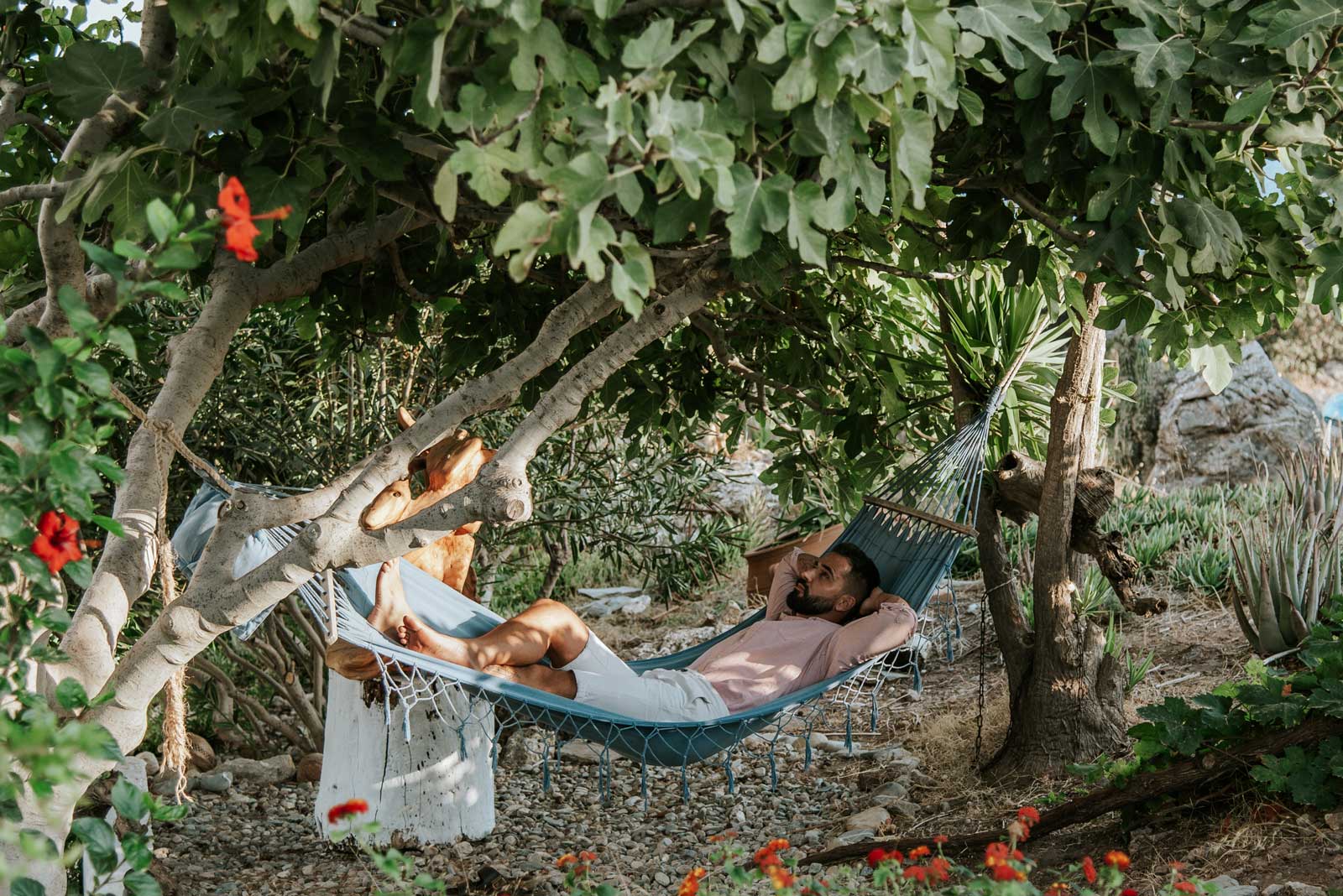 Men relaxing on a hammock at hotel