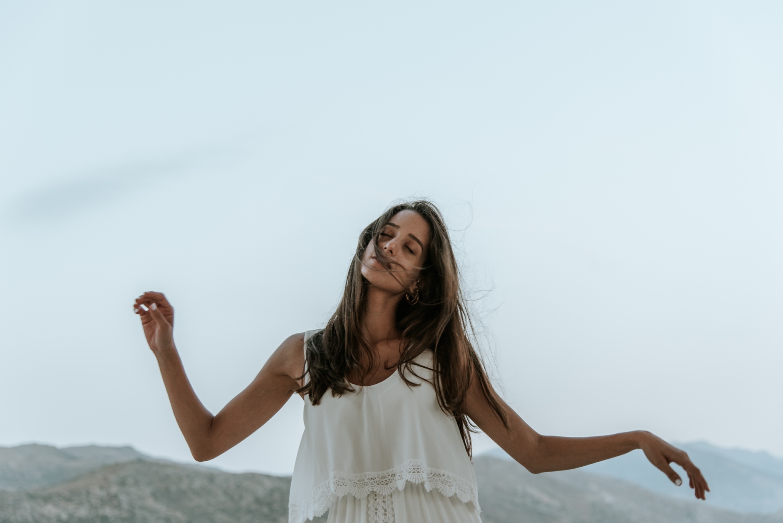 Woman dancing in white dress