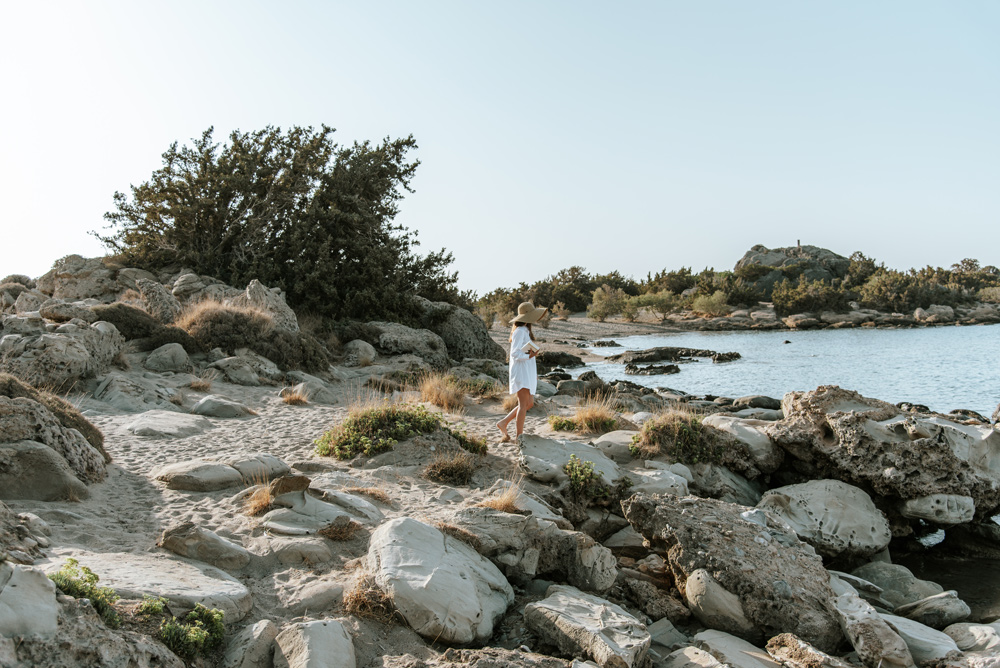 Woman walking at a rocky beach